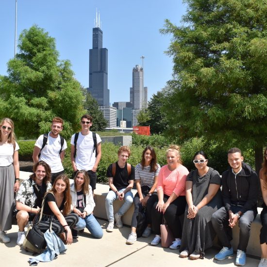 UIC students pose in front of the Chicago skyline and Willis tower