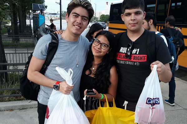 three students posing with their shopping bags