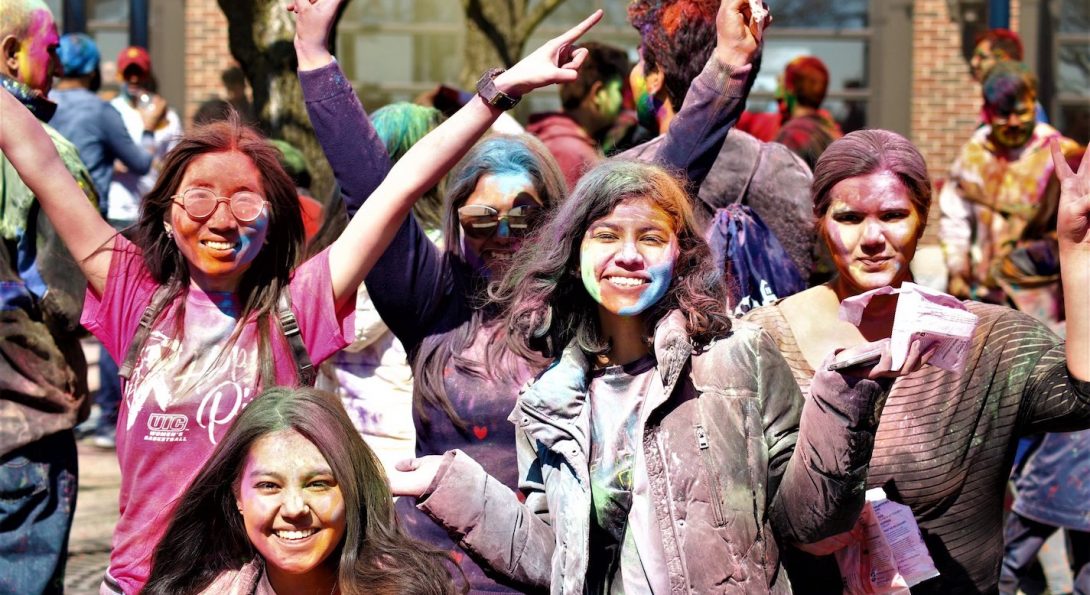 UIC students celebrate Holi with colored powder at Navy Pier.