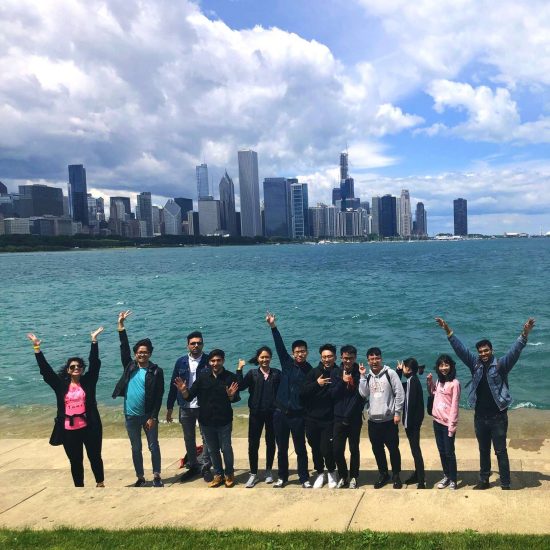 UIC international students posing in front of lake Michigan and Chicago downtown
