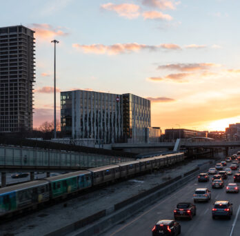 View of the UIC Halsted Blue Line stop during sunset with University Hall in the background. 